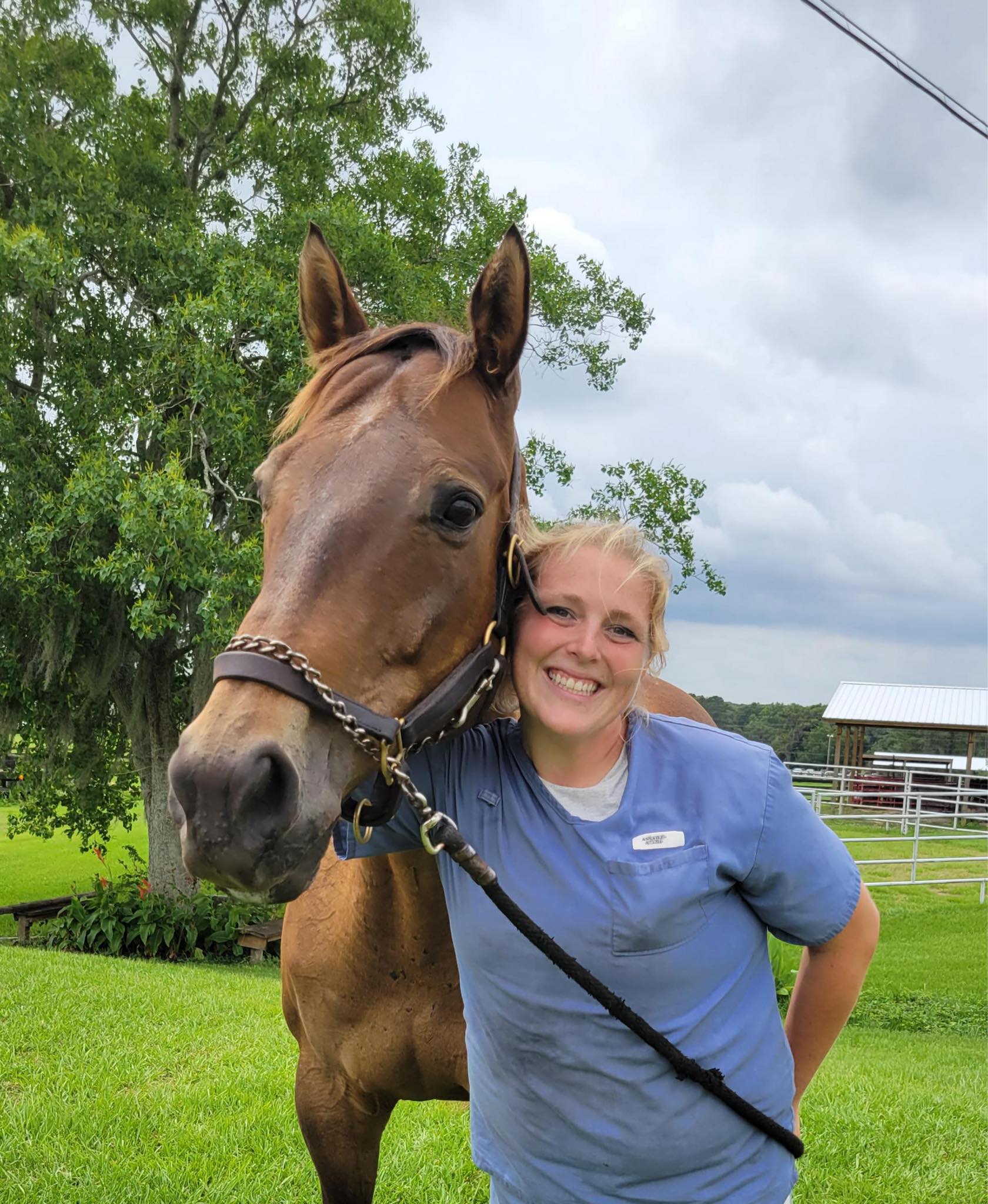 Woman in program posing with horse outside